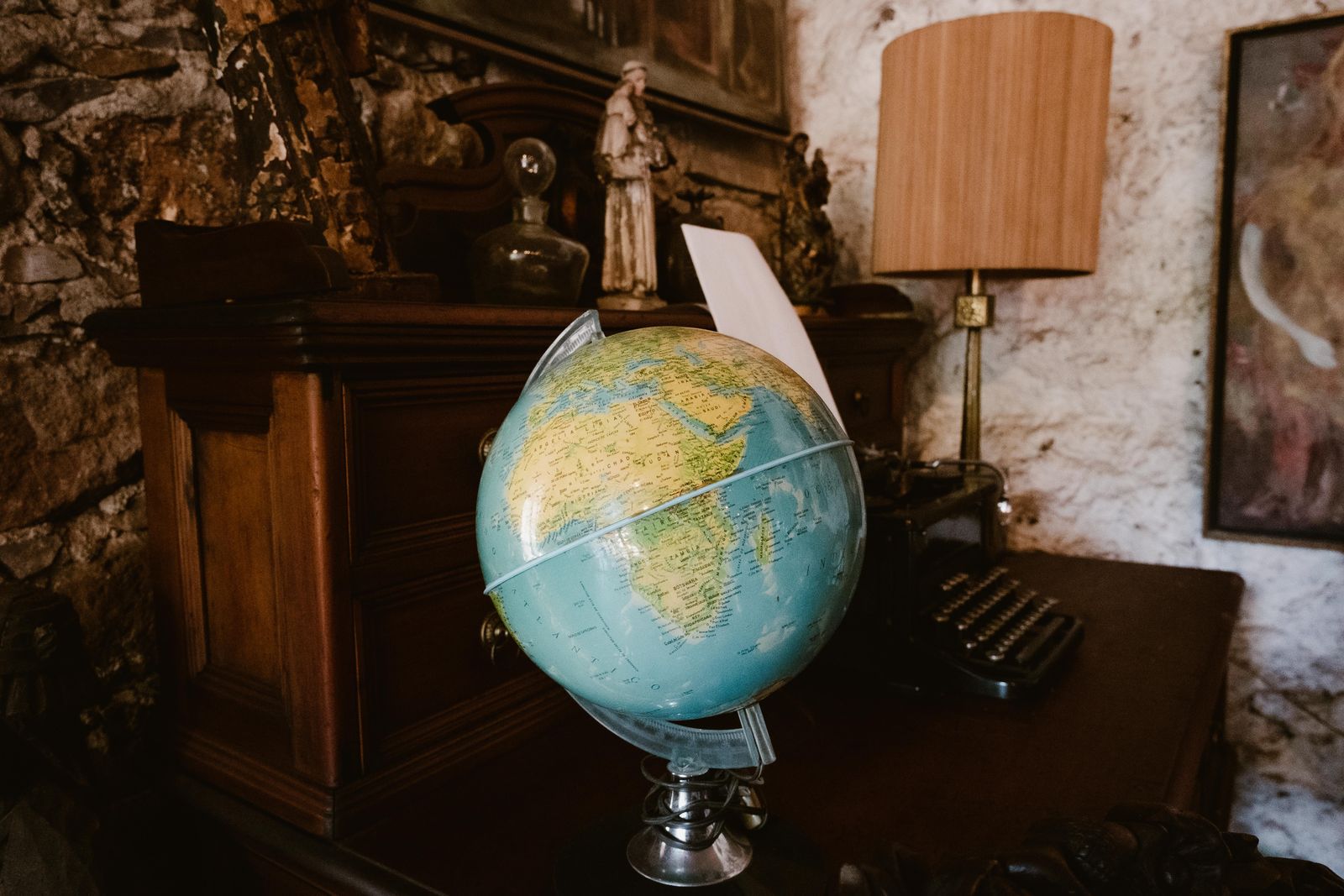 An antique globe in a wood-panelled study