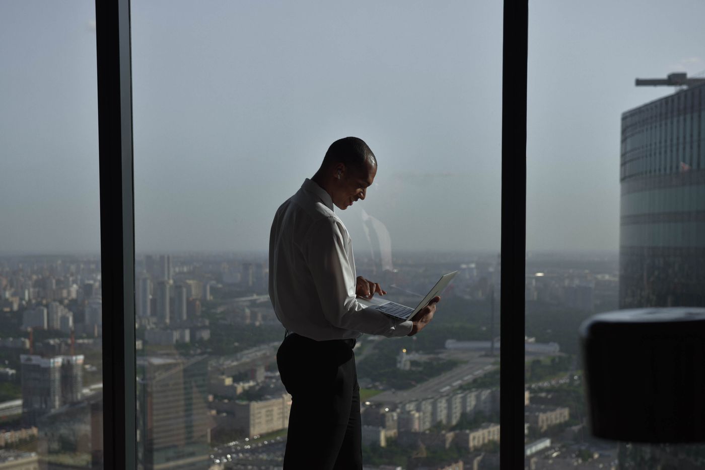 A founder on a call in a high-rise office above the city