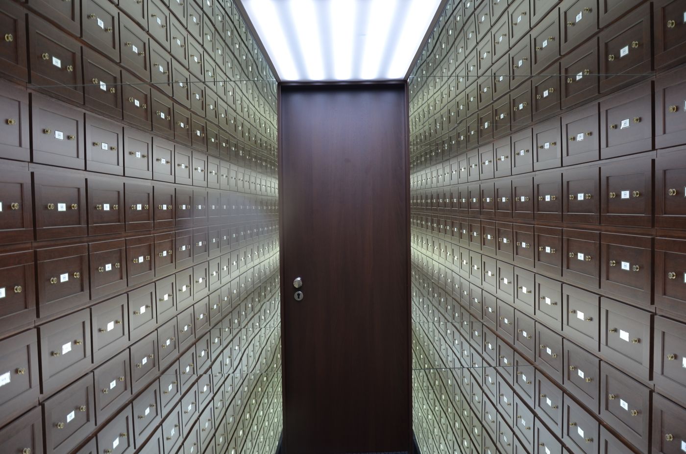 Wooden safe-deposit boxes lining the walls of a vault